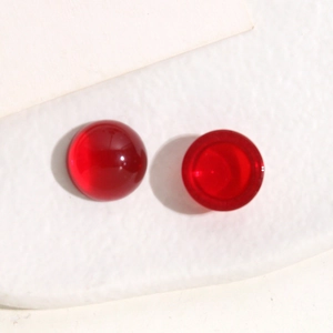 Macro view of 14mm translucent red resin cabochon parts with smooth round finish
