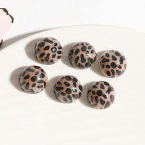 Detailed view of six acrylic leopard print round cabochons for DIY jewelry making