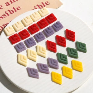 Macro shot of tiered geometric resin charms for DIY earrings in various vibrant colors