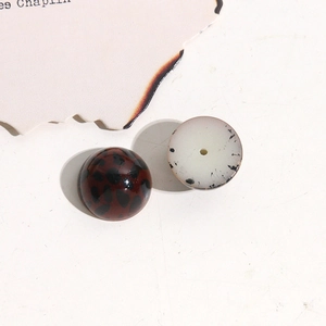 Detailed view of leopard and ink pattern acrylic half-round beads for DIY jewelry making