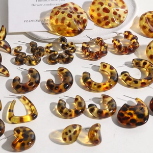 Close-up of leopard tortoise shell resin earrings in C-shape and geometric styles