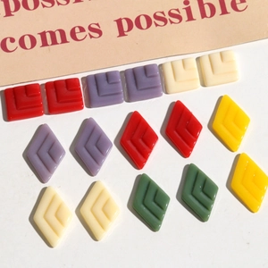 Detailed view of square and rhombus resin geometric charms for DIY jewelry making