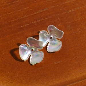 Macro shot of iridescent clover flower acrylic beads for DIY earring and hair accessories