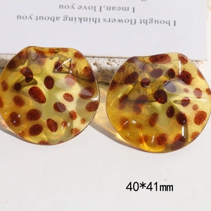 Macro detail of large 40x41mm retro leopard print resin C-shape stud earrings
