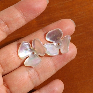 Macro shot of iridescent AB coated acrylic flower charms for DIY jewelry crafting