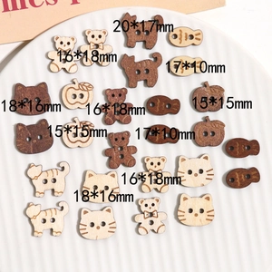 Close-up of wooden craft buttons in animal and apple shapes for DIY sewing accessories