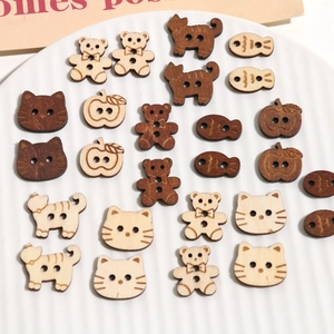 Macro detail of various wooden cartoon buttons in bear and cat shapes for DIY crafts