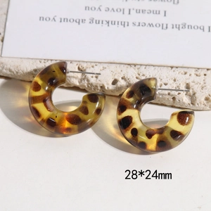 Detail view of leopard print resin C-shaped earrings on stone base, size 28x24mm