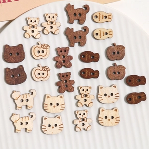 Detailed view of mixed wooden buttons in animal and apple shapes for DIY sewing