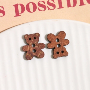 Close-up of bear-shaped wooden buttons with natural grain for DIY craft accessories