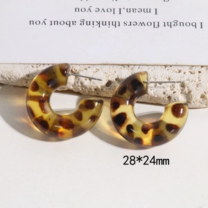 Macro view of C-shaped leopard print resin earrings with 28x24mm size measurements