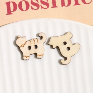 Detailed view of two cat-shaped wooden buttons with laser-engraved textures for DIY crafts