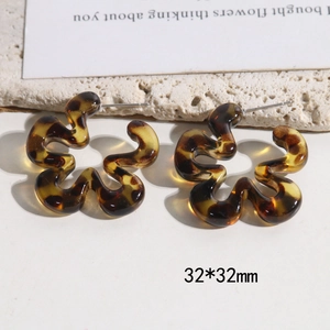 Detailed view of 32x32mm leopard print flower wave earrings in amber resin finish