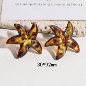 Close-up of tortoise shell leopard starfish earrings measuring 30x32mm in amber resin