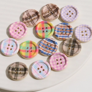 Close-up of assorted colorful checkered pattern round wooden buttons for DIY sewing projects