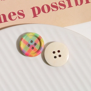 Close-up of checkered and cream wooden buttons on a textured plate for DIY crafts