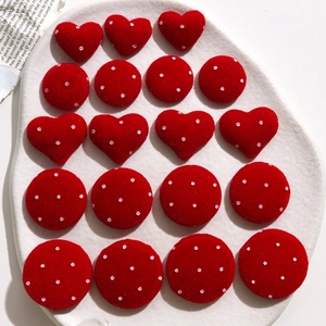 Macro view of red velvet polka dot heart and round charms for DIY hair accessories