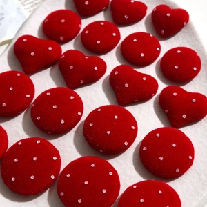 Macro detail of red velvet heart and round DIY buttons with glittery sequin dots