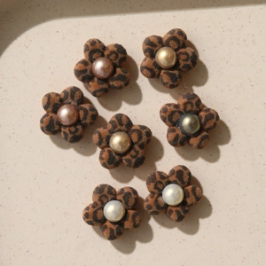 Detailed view of DIY leopard print flocked flower charms with pearl centers for jewelry