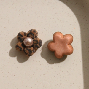 Detailed view of leopard print flocking flower charms with pearls for DIY jewelry making