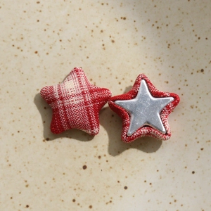 Dettaglio di bottoni a stella in tessuto scozzese rosso con inserto in metallo per DIY