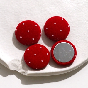 Close-up of red velvet polka dot round buttons for DIY craft and hair accessories
