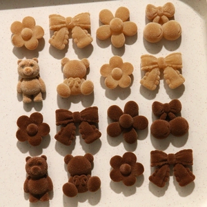 Detail of plush flocked DIY accessories in bear, flower and bow shapes for hair clips