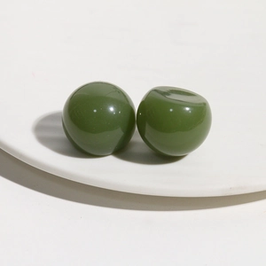 Close-up of deep green polished resin beads for DIY hairpins and jewelry accessories