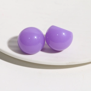 Close-up of glossy purple resin spherical DIY hair clip accessories on white base