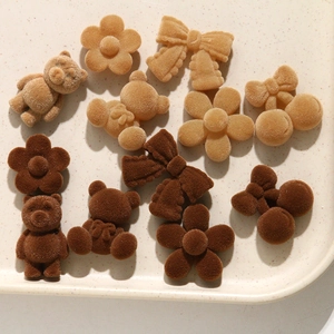 Detailed view of coffee-colored flocked bear and flower DIY hair clip accessories