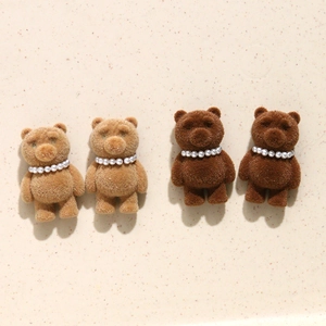 Detail of plush flocked bear ornaments with pearl necklaces for DIY hair accessories