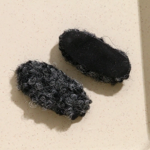 Detail of oval wool plush DIY accessories showing gray fleece texture and fabric back