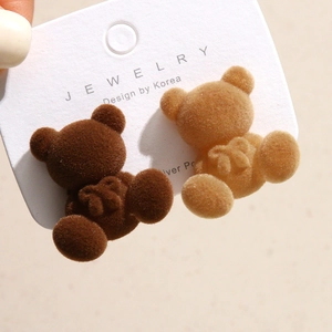 Detailed macro shot of flocking teddy bear hair accessories on a display card