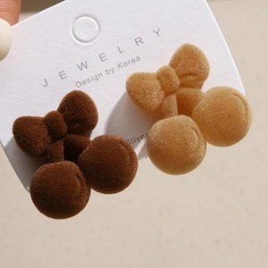 Detail of plush cherry hair accessories with flocked texture and delicate bows