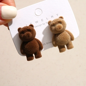 Close-up of cute flocked bear charms with soft velvet texture for DIY hair accessories