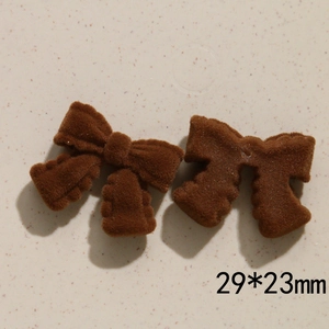 Detail view of two brown flocked bow accessories for DIY hair clips with size 29x23mm