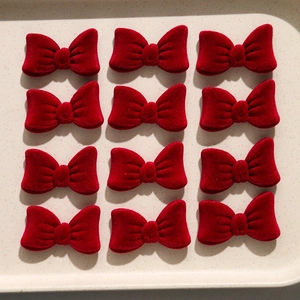 Set of 12 red velvet bow hair accessories arranged neatly for DIY crafting and hair styling