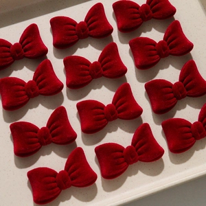 Close-up of premium burgundy velvet bow accessories for hair clips and DIY crafts