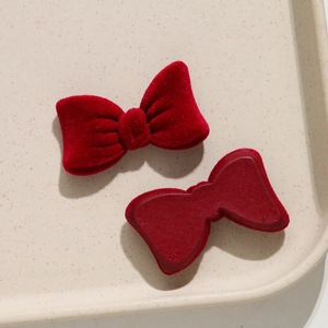 Close-up of wine red velvet bow hair accessory showing front texture and flat back base