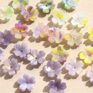 Macro view of pastel acrylic cherry blossom flower beads for DIY jewelry crafting