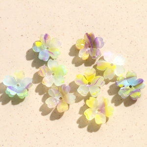 Macro shot of colorful marbled acrylic flower beads with holes for DIY jewelry making