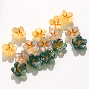 Macro detail of acrylic flower charms with iridescent finish and gold vein center
