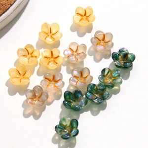 Macro detail of acrylic flower charms with gold centers for DIY jewelry making