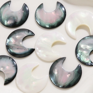 Macro detail of crescent moon resin patches with iridescent mother of pearl effect
