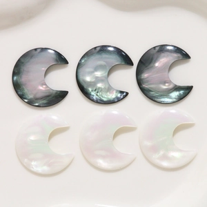 Macro detail of resin moon-shaped charms with iridescent faux shell texture for DIY jewelry