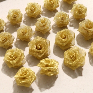 Macro view of golden mesh rose heads with curled petals for DIY jewelry accessories