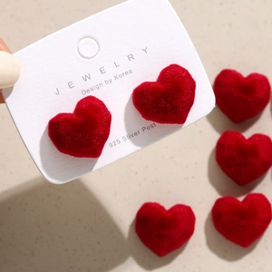Red velvet heart stud earrings with 925 silver posts on a professional display card