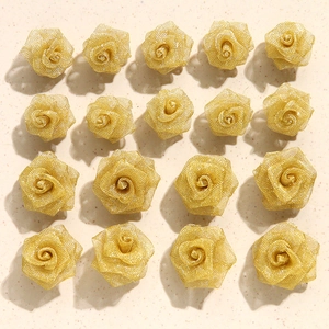 Flat lay of champagne gold wire mesh woven roses for DIY handmade jewelry accessories