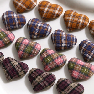 Detailed close-up of heart-shaped plaid fabric patches for DIY apparel accessories