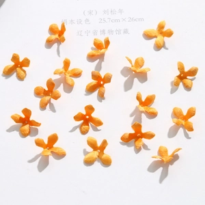 Detailed view of handmade orange fabric osmanthus flower petals for DIY jewelry accessories